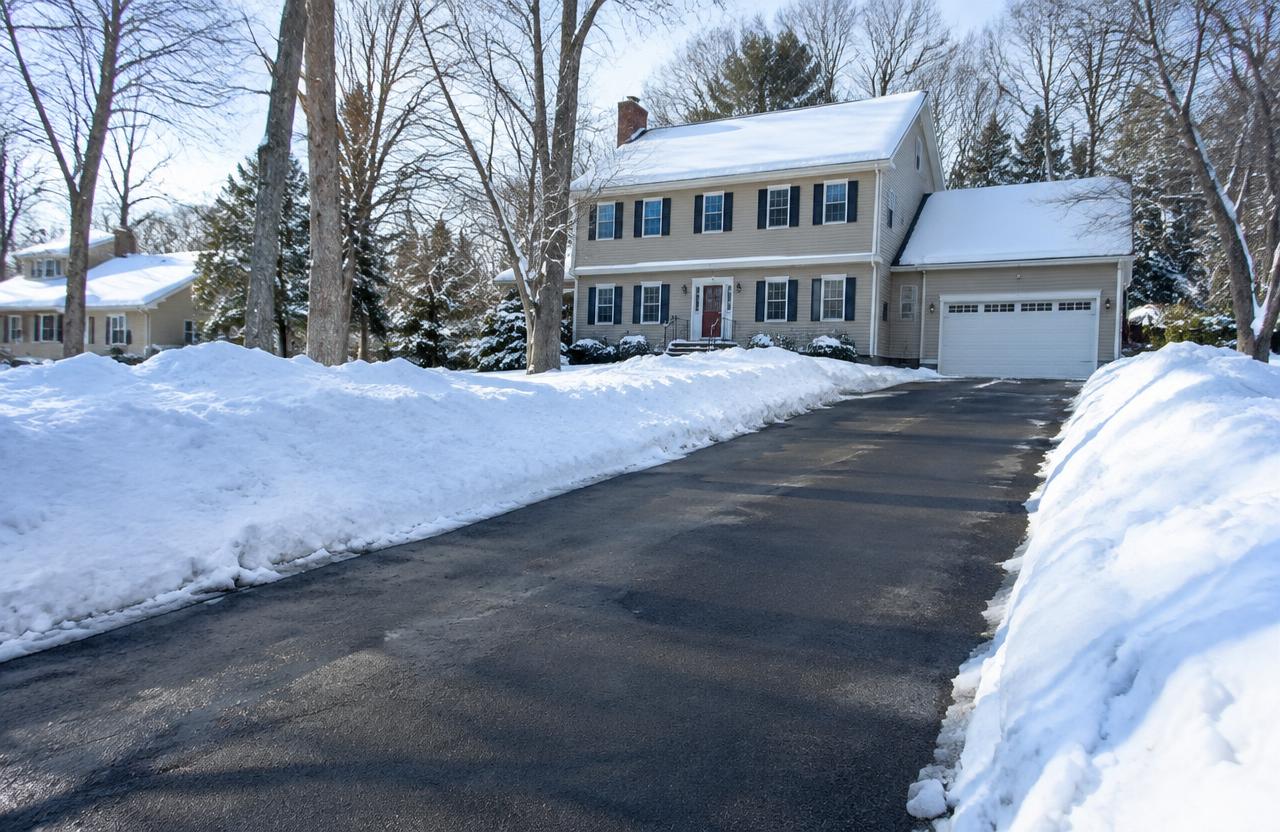 Plowed residential driveway lined with snowbanks